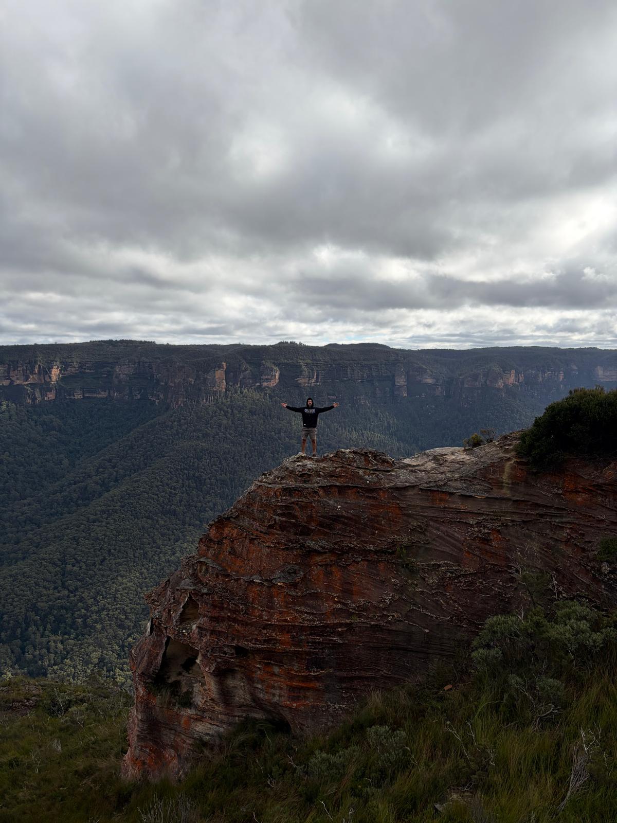 HFC outdoors — standing on a cliff overlooking the valley